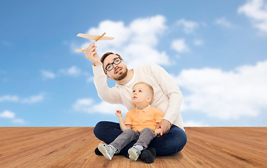 Image showing father and little son playing with toy airplane