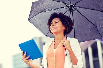 Image showing businesswoman with umbrella and tablet pc in city