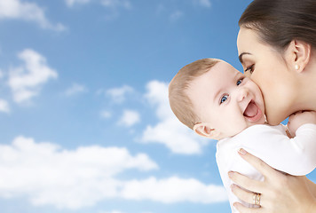 Image showing happy mother kissing adorable baby