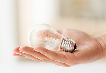 Image showing close up of hand holding edison lamp or lightbulb