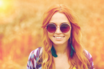 Image showing smiling young redhead hippie woman outdoors