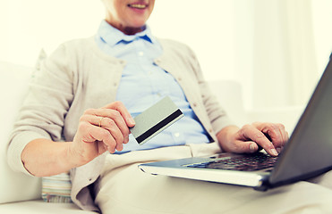 Image showing senior woman with laptop and credit card at home