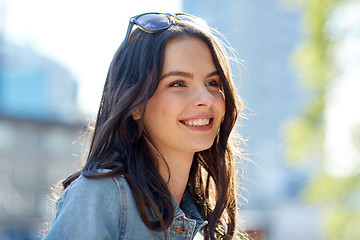 Image showing happy smiling young woman on summer city street
