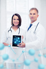 Image showing two doctors showing tablet pc with molecules