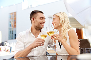 Image showing happy couple drinking wine at open-air restaurant