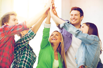 Image showing happy students giving high five at school