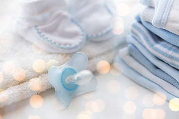 Image showing close up of soother and baby clothes for newborn