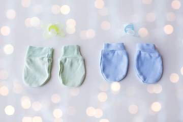 Image showing close up of baby mittens and soothers for twins