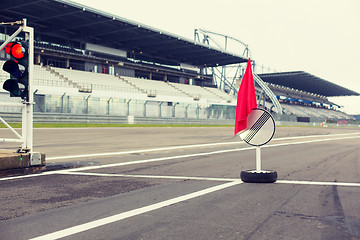 Image showing red traffic lights and road sign on race track