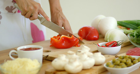 Image showing Woman preparing dinner chopping fresh ingredients