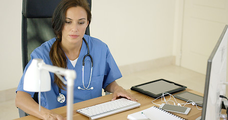 Image showing Doctor working at her desk in the office