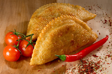 Image showing Caucasian cuisine. Cheburek pie on the wood background