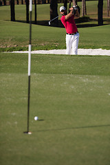 Image showing golfer hitting a sand bunker shot