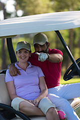 Image showing couple in buggy on golf course