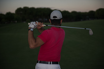 Image showing golfer hitting a sand bunker shot on sunset