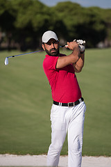 Image showing golfer hitting a sand bunker shot