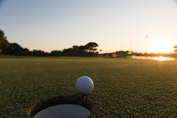 Image showing golf ball on edge of  the hole