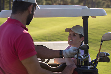 Image showing couple in buggy on golf course