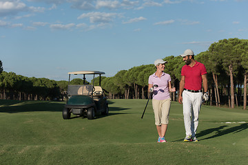 Image showing couple walking on golf course