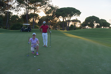 Image showing couple on golf course at sunset