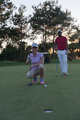 Image showing couple on golf course at sunset