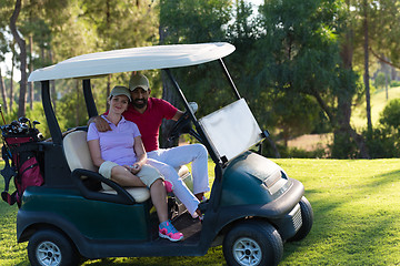 Image showing couple in buggy on golf course