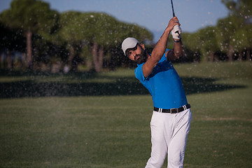 Image showing pro golfer hitting a sand bunker shot