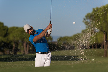 Image showing pro golfer hitting a sand bunker shot