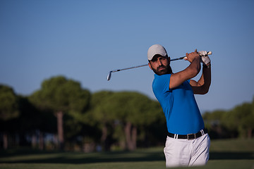 Image showing pro golfer hitting a sand bunker shot