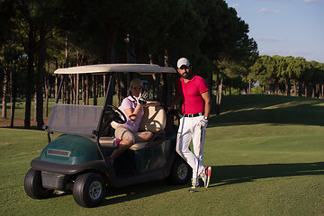 Image showing couple in buggy on golf course
