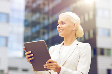 Image showing smiling businesswoman with tablet pc outdoors