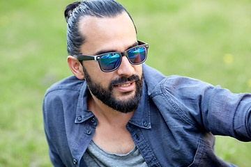 Image showing man in sunglasses at city street or park