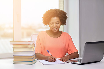 Image showing happy african american woman with laptop at home