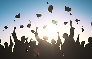 Image showing silhouettes of students throwing mortarboards