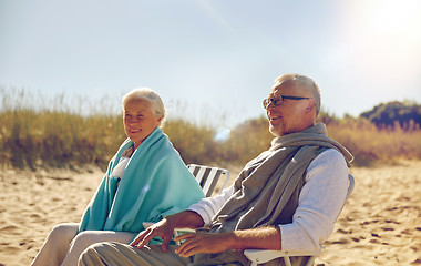 Image showing happy senior couple in chairs on summer beach