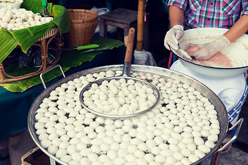 Image showing meat or rice balls frying in oil at street market