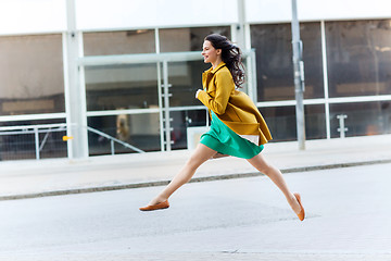 Image showing happy young woman or teenage girl on city street