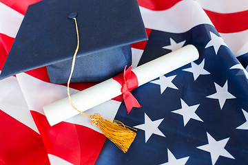 Image showing bachelor hat and diploma on american flag