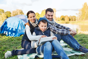 Image showing happy family with tablet pc and tent at camp site