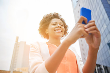 Image showing happy african businesswoman with smartphone