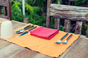 Image showing close up of cutlery with glass and napkin on table