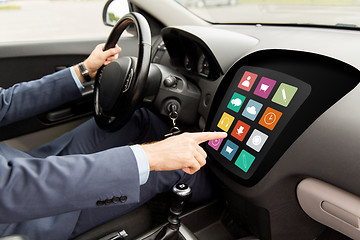 Image showing man driving car with menu icons on board computer