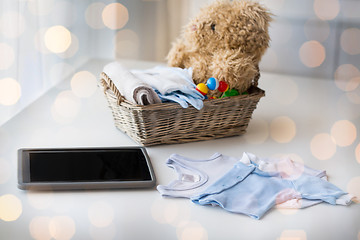 Image showing close up of baby clothes, toys and tablet pc