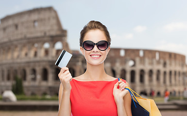 Image showing woman with shopping bags and credit card in rome