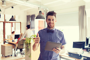 Image showing happy creative male office worker with tablet pc