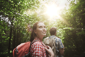 Image showing group of smiling friends with backpacks hiking