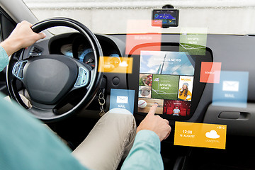 Image showing man driving car with news on board computer