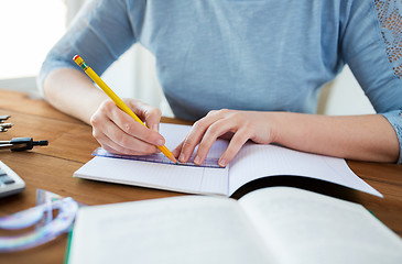 Image showing close up of hands with ruler and pencil drawing 