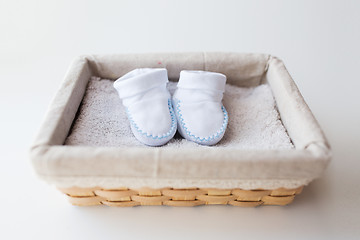 Image showing close up of baby bootees for newborn boy in basket