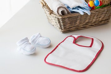 Image showing close up of baby bootees, bib and newborn stuff